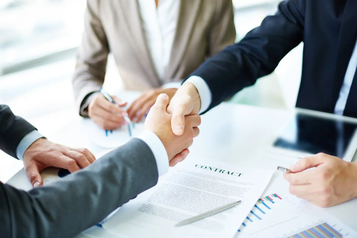 Two men handshaking over a satisfying debt settlement